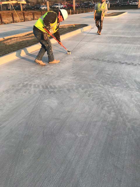 men applying concrete joint sealant